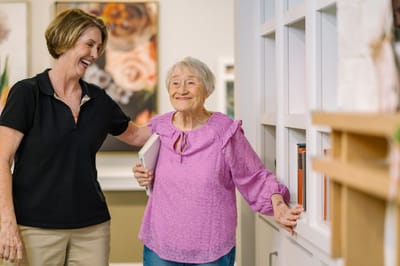 Resident and staff member interacting in a communal area