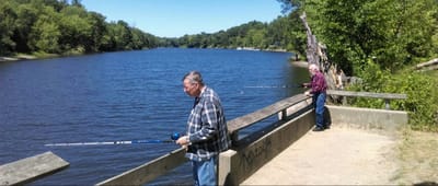 Two residents fishing by a river