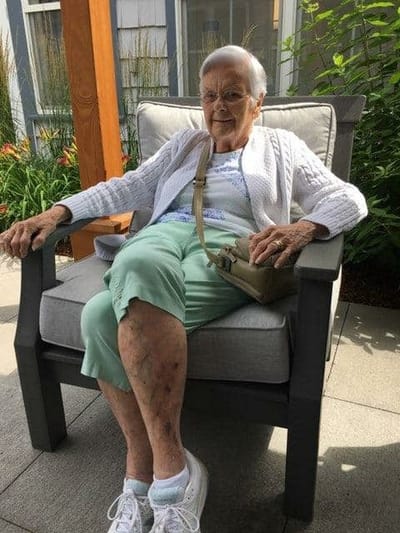Senior resident enjoying the outdoors in a comfortable chair