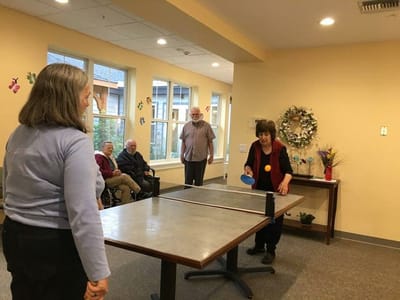 Residents engaging in a game of table tennis