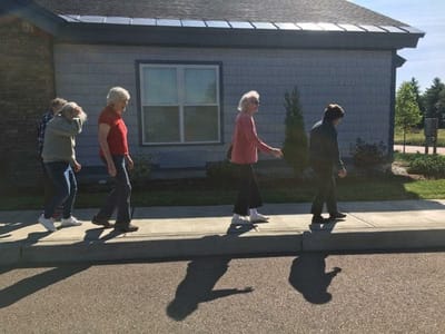 Residents walking outside along the pathway
