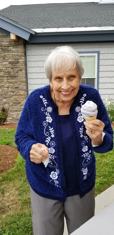 Elderly resident enjoying ice cream in the garden