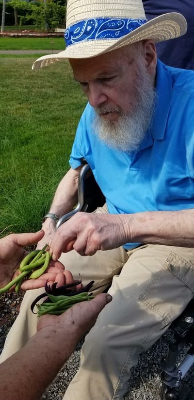 Resident gardening with assistance outside