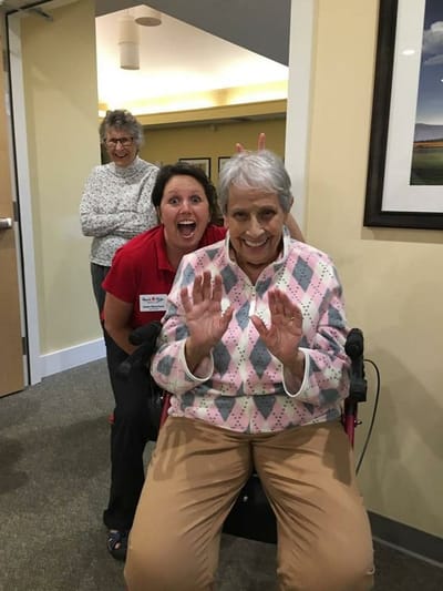 Residents and staff enjoying a joyful moment indoors