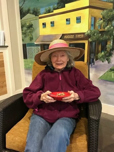 Resident enjoying food in a cozy indoor area