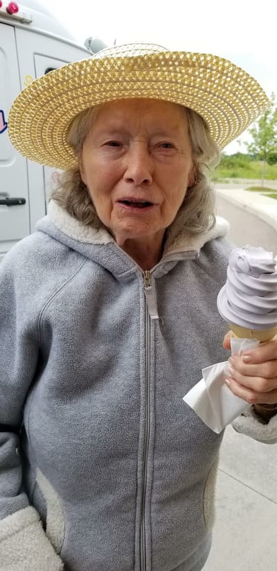 Elderly woman enjoying ice cream outdoors