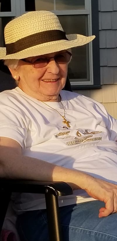 Smiling resident outdoors wearing a hat