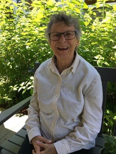 Smiling resident sitting outdoors in a garden