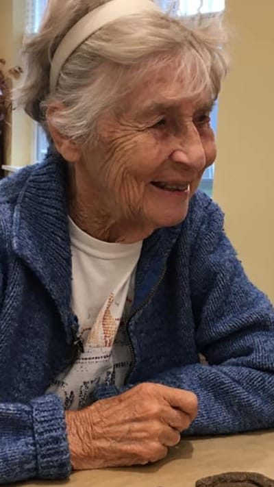 Resident smiling in a cozy indoor setting