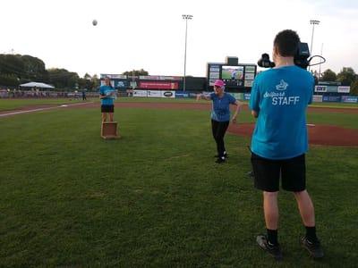 Staff and residents participating in a baseball activity