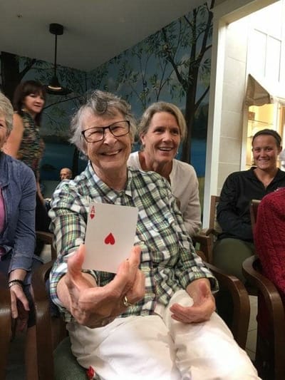 Residents engaged in a card game activity in a common area