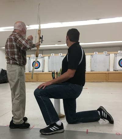 Residents participating in an archery activity