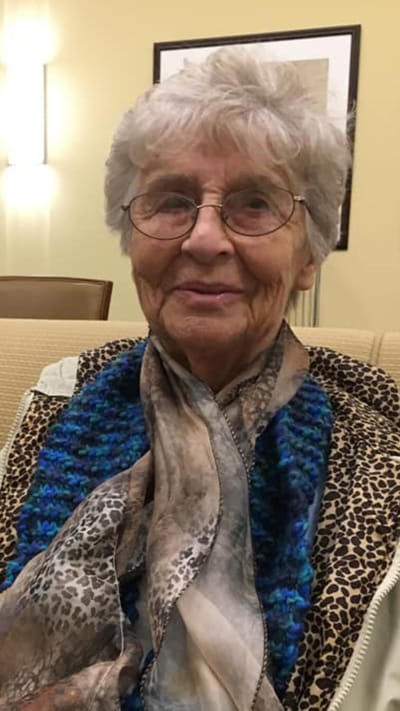Senior resident smiling in a cozy lounge area