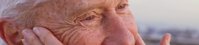 Close-up of a smiling elderly person's face