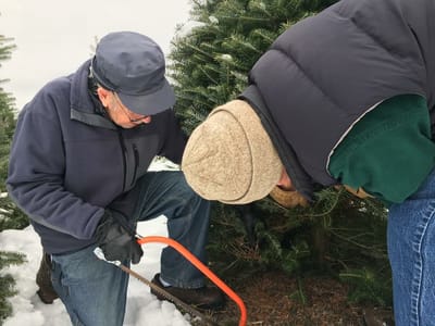 Two men working together outdoors during winter