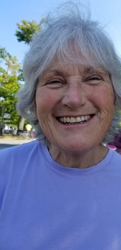 A joyful resident smiling outdoors