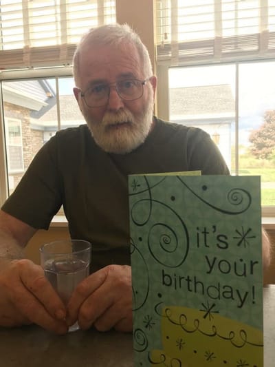 Resident celebrating a birthday with a card