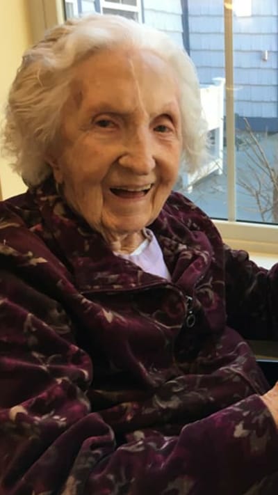 Elderly resident smiling by a window