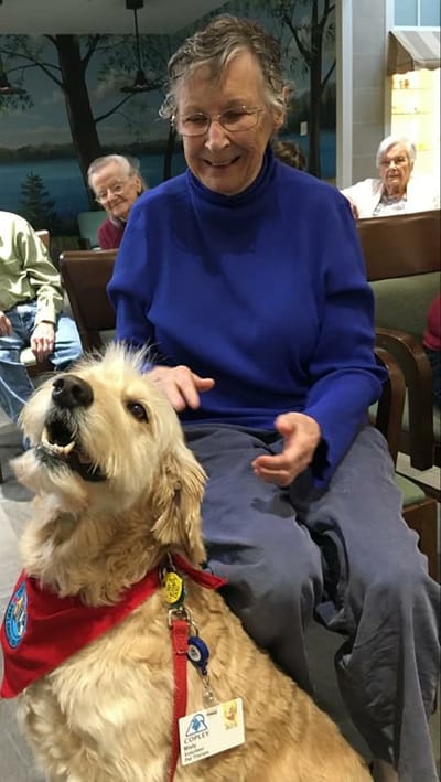 Resident interacting with a dog in a common area