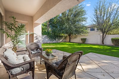 Outdoor seating area with lawn and trees