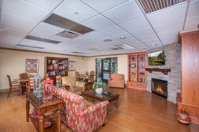 Bright common area with seating and a fireplace