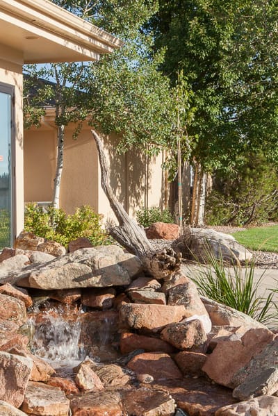A landscaped outdoor water feature with stones