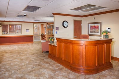 Reception area with wooden front desk in a facility