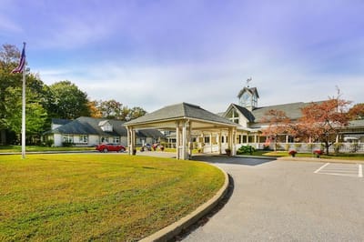 Exterior view of a senior living facility with landscaped grounds