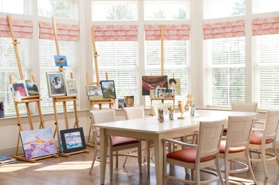Activity room with art easels and artwork displayed