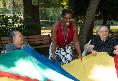 Residents and staff engaged in a colorful outdoor activity
