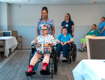 Residents participating in an activity with staff support