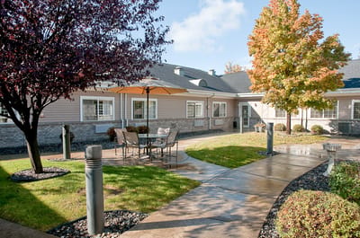 Outdoor seating area with umbrellas and landscaping