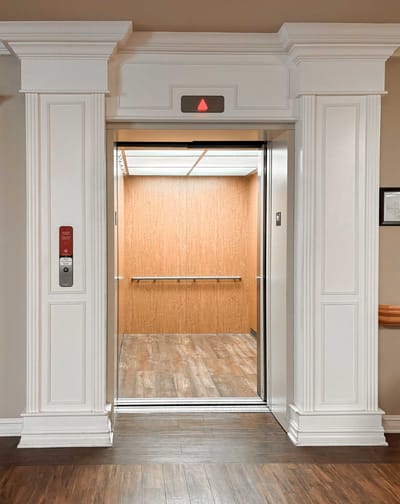 Inside view of a facility elevator with wood paneling