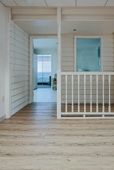 Interior view of a hallway with wood flooring