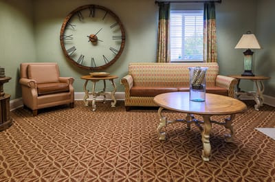 Cozy common area with seating and decorative clock