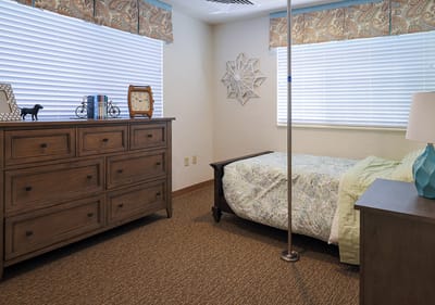 A private resident room with a bed and furniture
