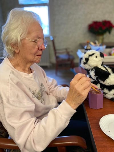 Senior resident engaged in an arts and crafts activity.
