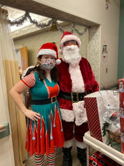 Staff dressed as Santa and an elf celebrating Christmas