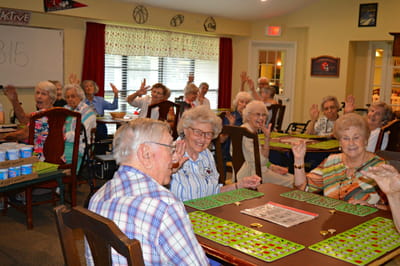 Residents enjoying a bingo game in a shared activity area