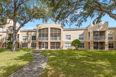 Exterior view of The Barrington facility with landscaped space