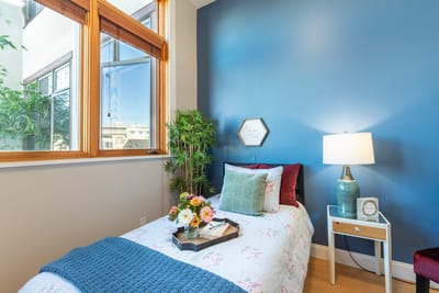 A cozy resident room with a bed and decor