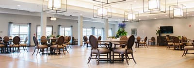 Bright common area with dining tables and chairs