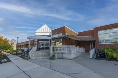 Front entrance of a senior living facility with pathways
