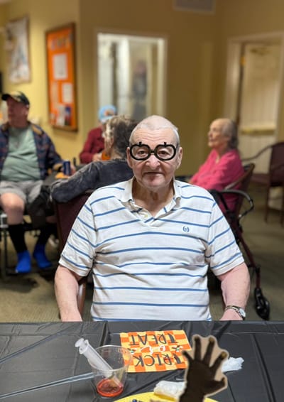 Happy resident wearing fun glasses during an activity