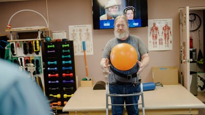 A resident participating in a therapy session with equipment