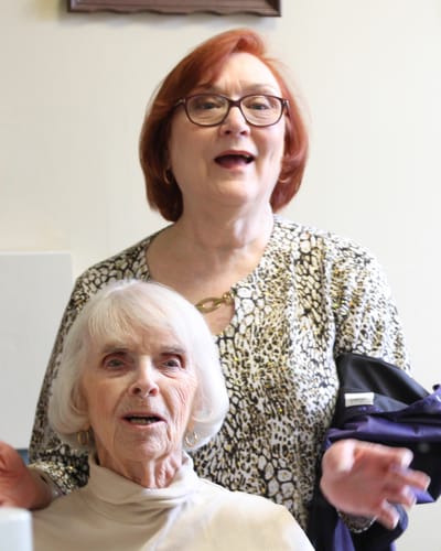 Two women smiling in a bright room