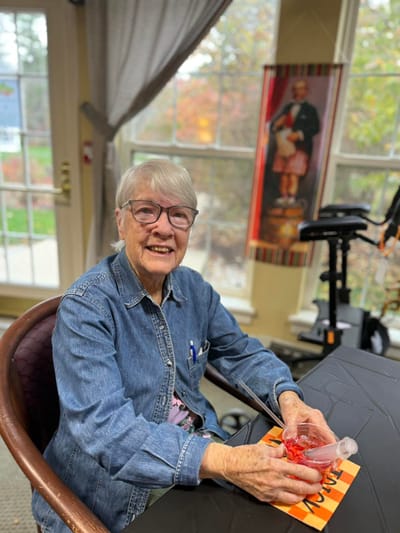 A resident smiling while sitting at a table