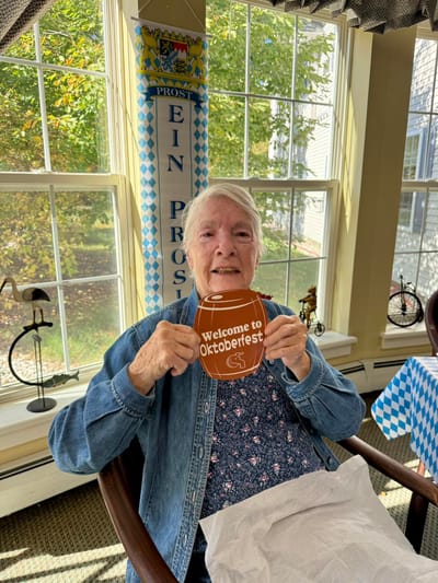 Resident celebrating Oktoberfest with a mug