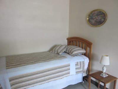Cozy private room with a bed and lamp