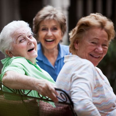 Three smiling residents enjoying time together
